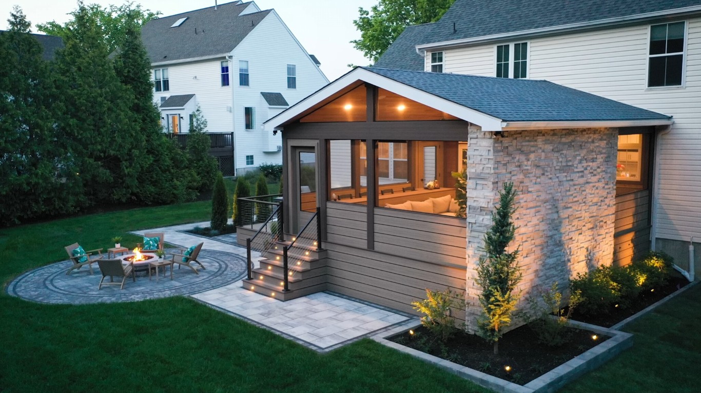 Modern sunroom with stone accents at twilight showing seamless indoor-outdoor living in Peoria, AZ